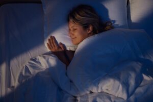 Your HVAC System Can Enhance Sleep. Woman sleeping peacefully in her bed.